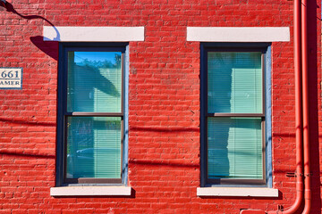 Red Brick Wall with Blue Trim Windows and Number 661 Eye-Level View