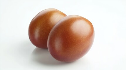 Obraz premium Two brown eggs on a white surface