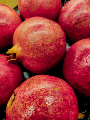 close-up of red ripe pomegranates fruits pomegranate colorful market pattern background