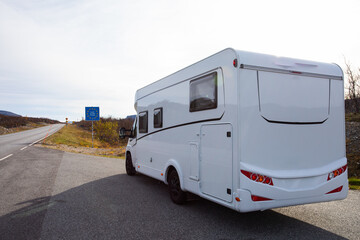 White camper van parked in a serene pine forest, offering a tranquil escape into nature near Finland border