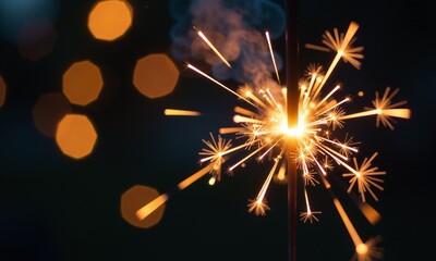sparkler golden sparks glowing embers dark background bokeh