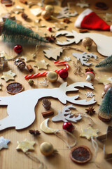 Various Christmas decorations in neutral colors on wooden background. Selective focus.