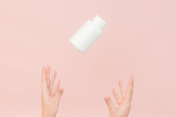 Female hand holding cosmetic container for cream, vitamins, pills. Cosmetic beauty packaging