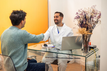 Dentist shaking hands with patient after successful dental checkup