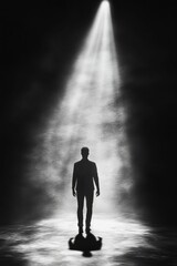 Silhouette walks toward light, shadowy figure.