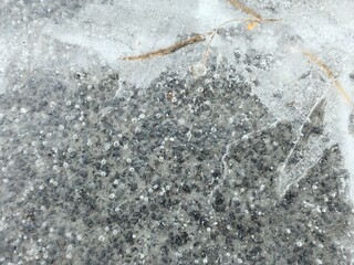 Ice crust on the pavement, paving stones, frozen water on a pavers