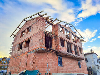 A new three-story house with a terrace is under construction in city Harrachov