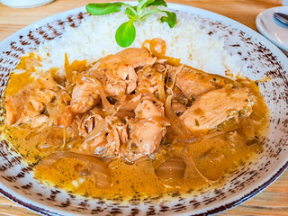 Spicy teriyaki chicken fillet pieces with rice, green onions and sesame seeds