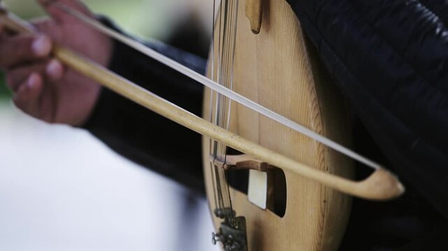Man play Kemenche Lyra, stringed bowed musical instruments originating in the Eastern Mediterranean and Black Sea, particularly in Armenia, Greece, Iran, Turkey, and Azerbaijan