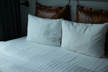 A large sleeping bed with white bedding.
