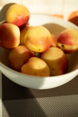 Peaches on a plate. Fruit on the table. Useful food.