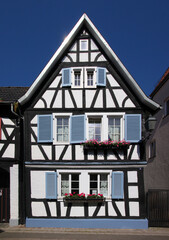 Half-timbered wooden residential house with its symmetrical gable in the old village of Jockgrim, Rheinland-Pfalz in Germany