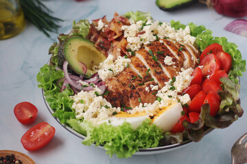 A bowl with cobb salad, traditional American dish