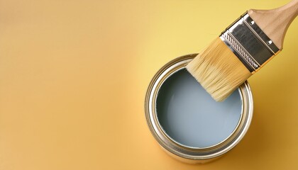 A scene of dipping a brush into an empty can and mixing paint
