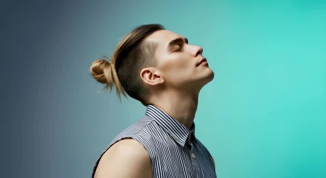 Androgynous model with undercut hairstyle in profile on gradient background