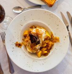 Huevos rotos con morcilla, scrambled eggs with blood sausage, potatoes and caramelized onions