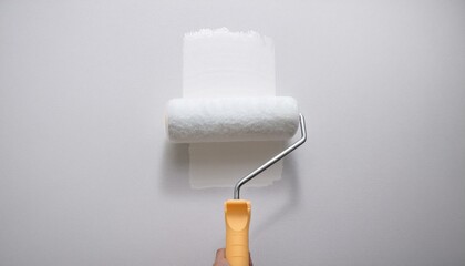 Obraz premium Roller applying paint to wall, scene of smooth rolling on wall