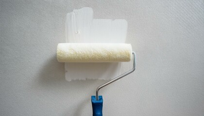 Obraz premium Roller applying paint to wall, scene of smooth rolling on wall