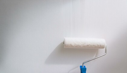 Obraz premium Roller applying paint to wall, scene of smooth rolling on wall