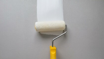 Obraz premium Roller applying paint to wall, scene of smooth rolling on wall