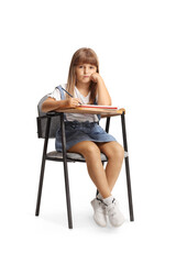 Sad little girl sitting in a school chair