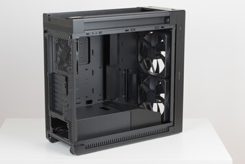 Side view of empty  big tower, PC case, chasssis, without upper and  tempered-glass left panel. At the bottom is a cover for power supply unit.