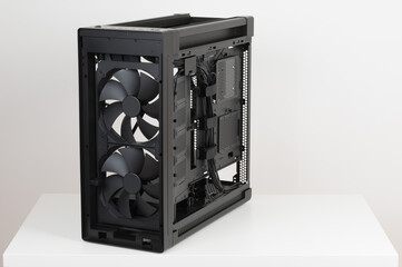Side view of empty  big tower, PC case, chassis, without upper , front, right  metal panel  and  tempered-glass left  panel. Two  pre-installed system extra-thick 200 x 38 mm front fans.