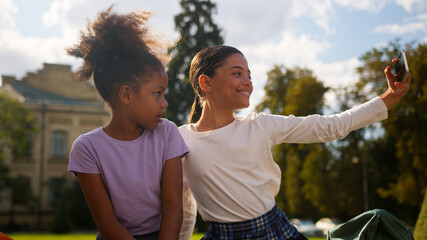 School study elementary education outdoors photo video vlog selfie posing happy little girls classmates students kids children female schoolgirls multiethnic African pupils using phone addicted blog