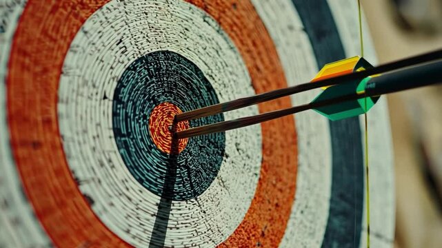 Bullseye: Precision and Accuracy in Archery. Close-up view of two arrows hitting the bullseye of a weathered archery target.  A compelling image representing precision, focus, and success. 