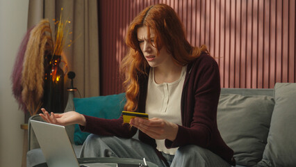Confused sad anxious woman Caucasian female girl buyer using laptop at home bank app payment online...