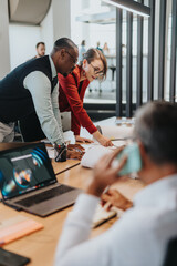 A group of diverse business colleagues gathered around a table during a brainstorming session,...