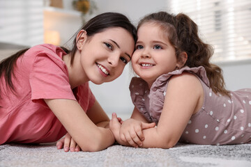 Portrait of cute little girl and her sister indoors