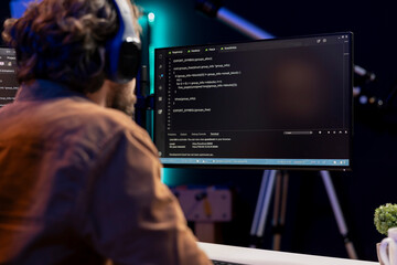 Computer scientist listening music while securing company servers from virus attacks. IT remote...