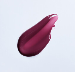 A burgundy maroon shade of lipgloss, lipstick smear, cosmetics beauty product texture, liquid blush, lipgloss swatch