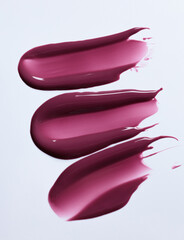 A burgundy maroon shade of lipgloss, lipstick smear, cosmetics beauty product texture, liquid blush, lipgloss swatch