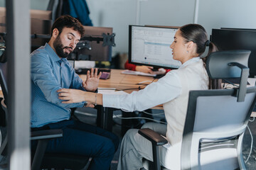 A man and woman engage in a collaborative discussion at an office desk, showcasing diversity and teamwork in a modern workplace environment.