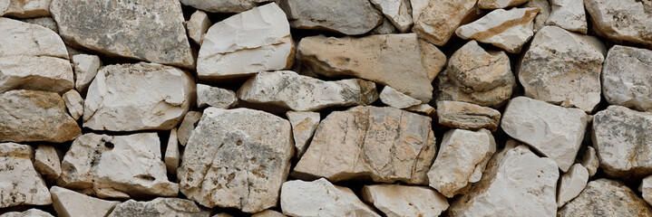 Beige stonework stone texture background, close-up panoramic image