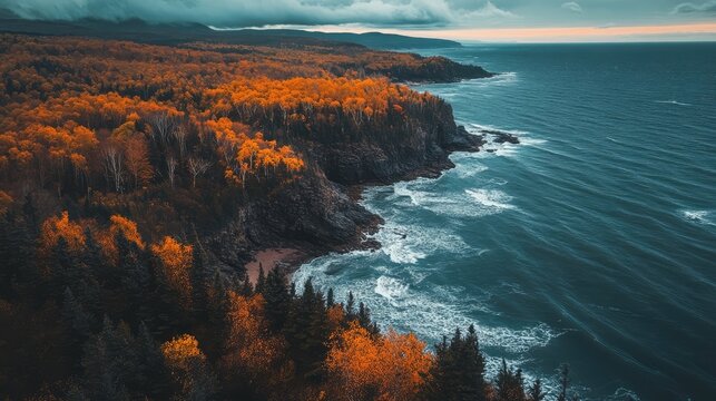 Autumn coastline with vibrant foliage overlooking turbulent ocean waves under dramatic clouds at twilight.