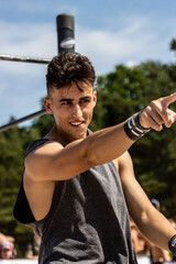Fototapeta premium A photo from a beachside competition showcasing athletes performing impressive calisthenics moves, demonstrating strength and agility against a scenic coastal backdrop.