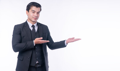 Advertisement gesture pleased concept. Confident positive handsome young businessman holding own hands presenting product or copy space or invite people while standing over isolated white background.