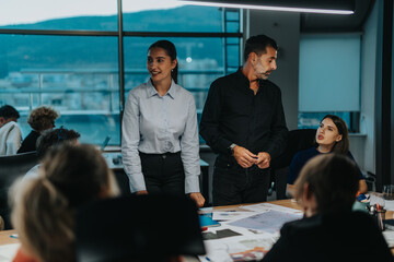 Different aged colleagues engage in a brainstorming session, fostering teamwork and creativity. The...
