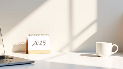 Modern home office setup with a white desk, soft wood tones, and a black and white 2025 desk calendar. Warm lighting creates a calming, inspiring atmosphere for a clean, productive workspace.