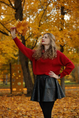 autumn portrait of young woman in red sweater