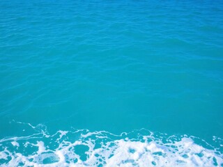 Obraz premium Blue turquoise ocean water with foamy waves, texture, horizon, summer