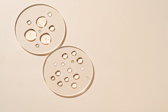 Minimalist composition of liquid golden drops on glass plates - Powered by Adobe