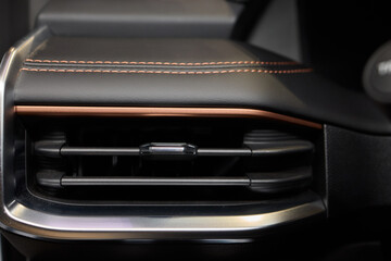 Closeup of car dashboard air vents near gear shift