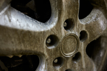 Closeup shot depicting a Dirty Car Wheel that is covered with Mud and Grime buildup