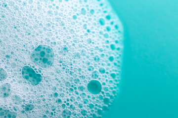 white foam bubbles on a blue background.Cleanliness and hygiene concept.Foam Water Soap Suds.foam...