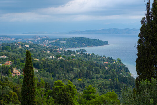 Beautiful landscape of Corfu island. View of green coast and sea. Stormy sky with clouds over sea