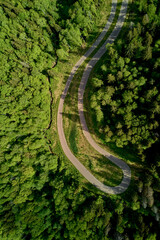 Fototapeta premium Vertical aerial view of a roller ski track in a forest area